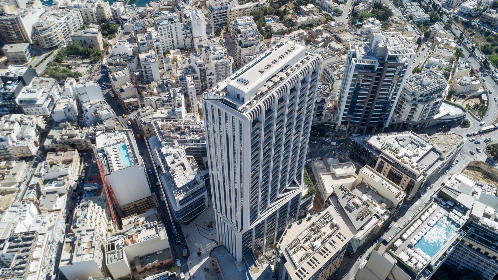 Mercury Tower under construction in Mriehe, surrounded by dense Maltese urban development