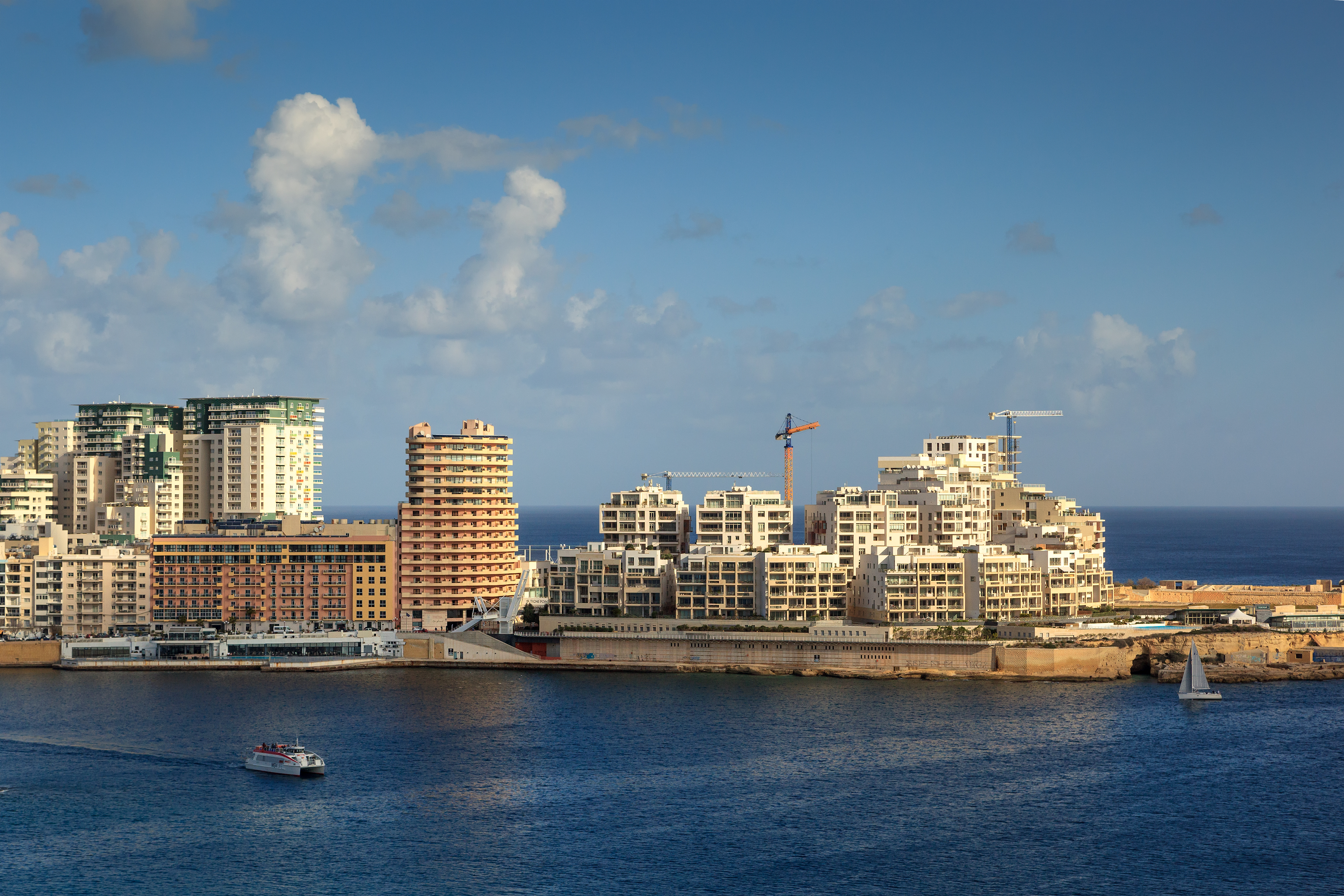 Sliema skyline from Valletta showing dense apartment blocks and a construction crane